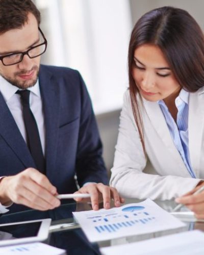Portrait of smart businesswoman and businessman working in office